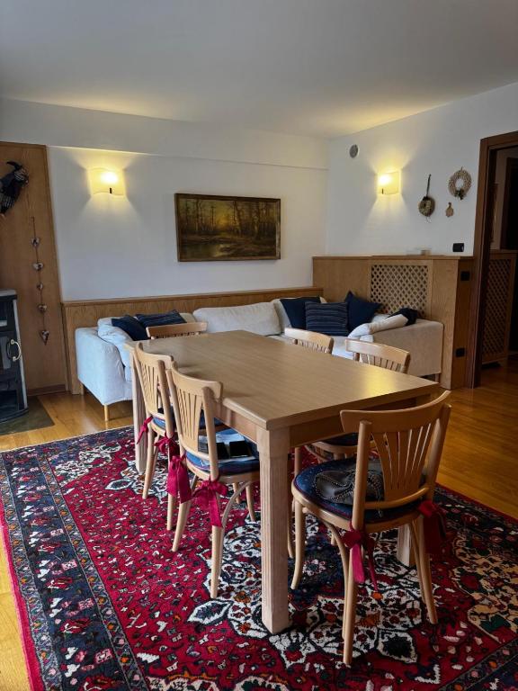 a living room with a wooden table and chairs at Mountain house Pieve di Cadore in Pieve di Cadore