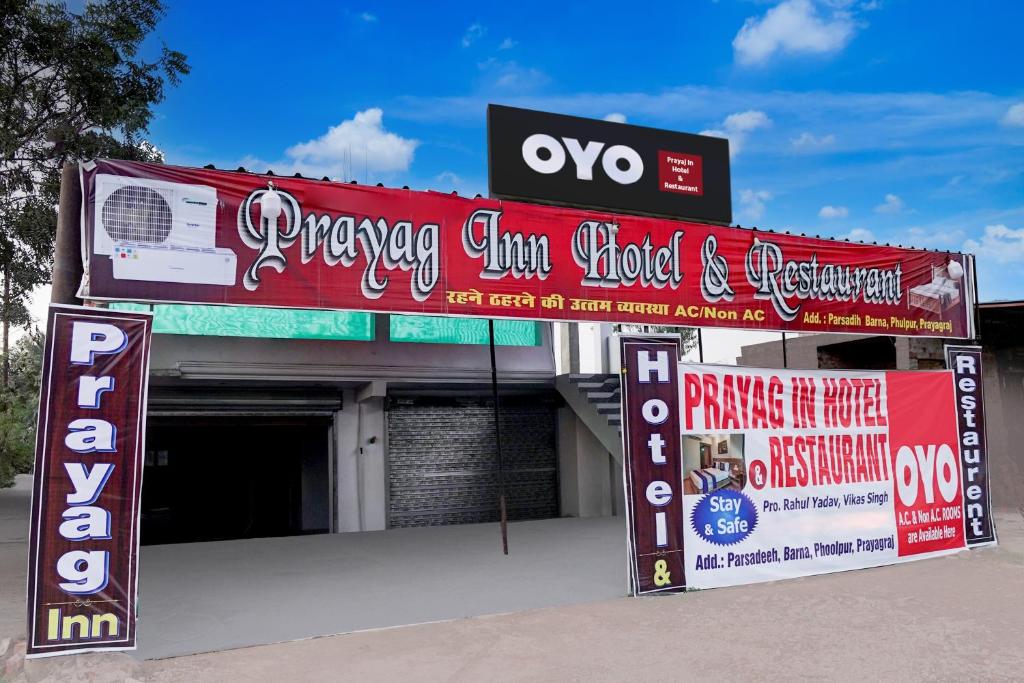 a building with signs in front of it at SPOT ON Prayaj In Hotel & Restaurant in Prayagraj
