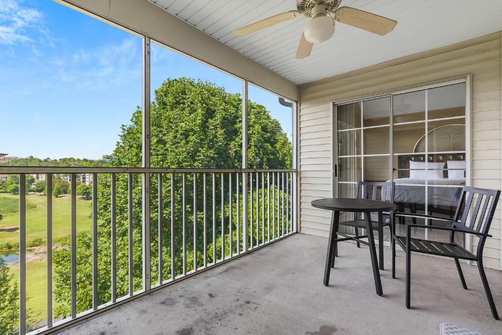 a patio with a table and chairs on a balcony at Spring Creek Escape - Balcony with Views in Branson