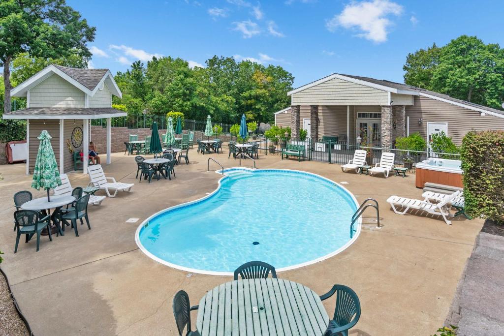 a swimming pool with chairs and tables and a patio at Boatin & Floatin on Table Rock Lake in the Ozarks in Kimberling City
