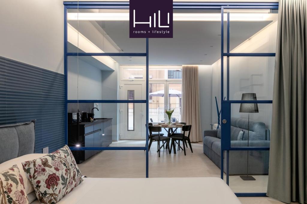 a room with a bed and a dining room at Casa Foligno by Hili in Rome