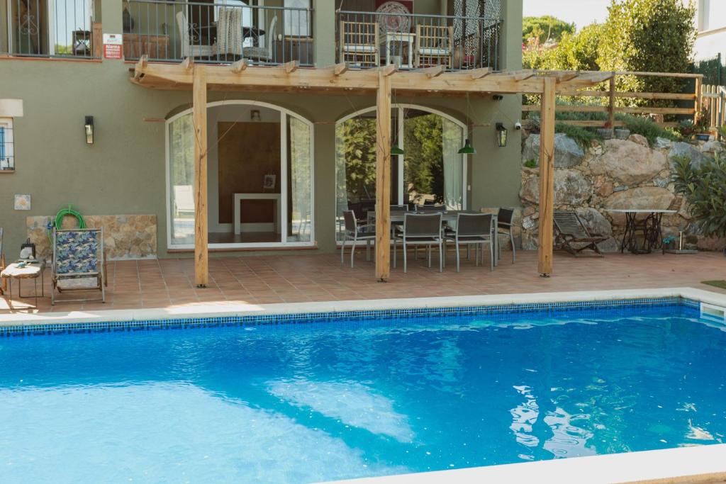 a swimming pool in front of a house at La Platjeta in Calonge