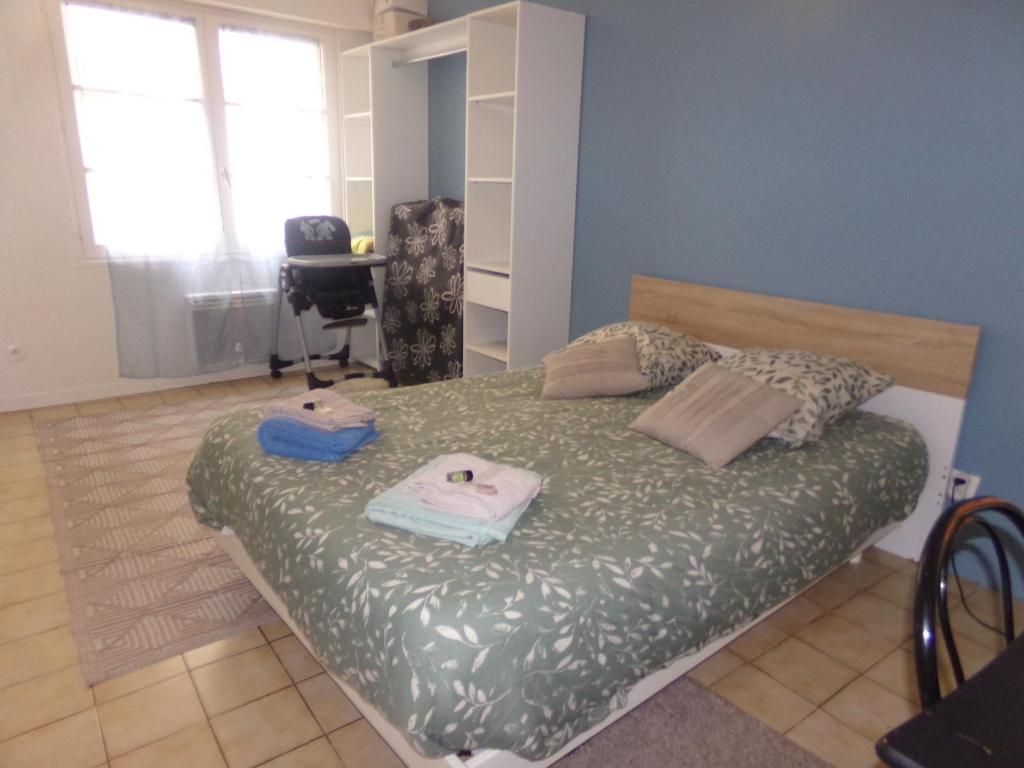 a bedroom with a bed with two towels on it at Le Goéland in Dieppe