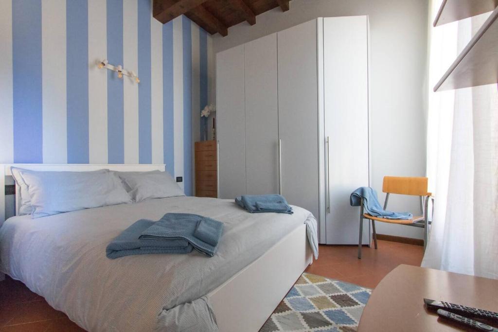 a bedroom with a bed with blue and white stripes at La Piazzetta in Cento