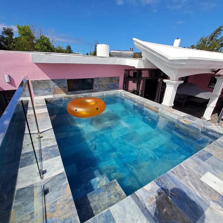 a swimming pool with a beach ball in the middle of a house at Charming Villa with Pool in Souillac in Souillac