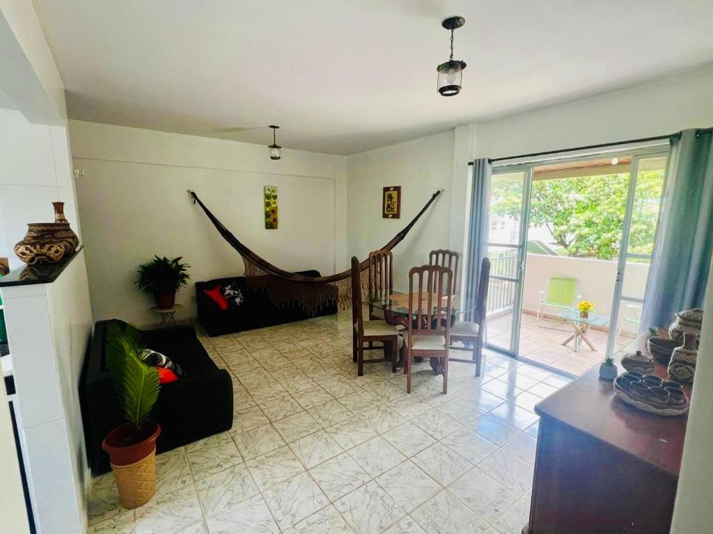 a living room with a couch and a table and chairs at COP 30, Mosqueiro - Apto pé na areia in Belém