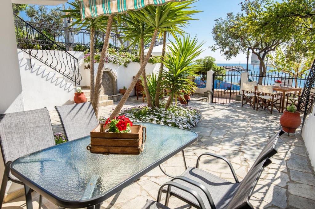 a blue table and chairs on a patio with a view of the ocean at D&D Holiday Studios in Potos