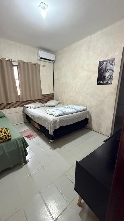 a bedroom with a bed and a table in it at Minas Hotel Uberlândia in Uberlândia