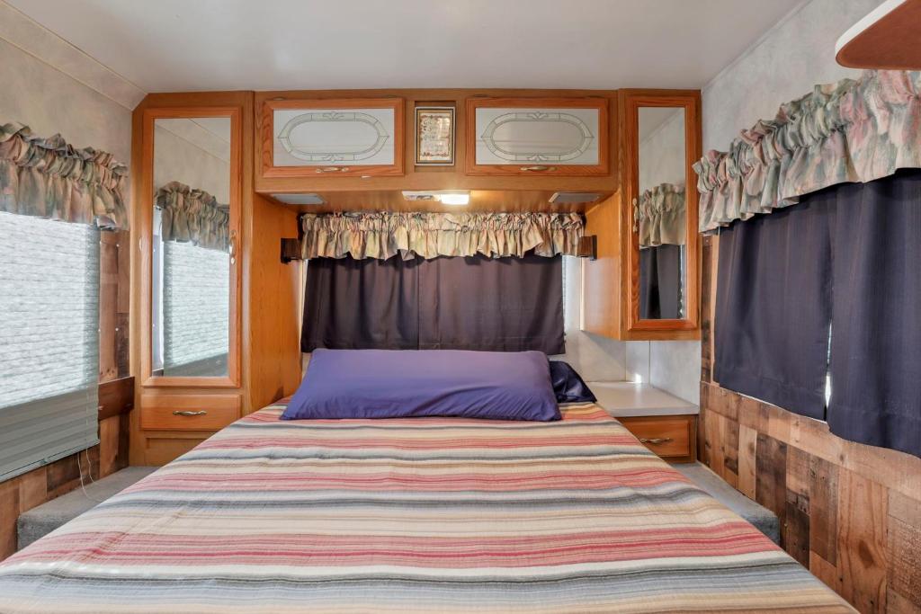a bedroom with a large bed in a tiny house at RV Camper in New Lexington