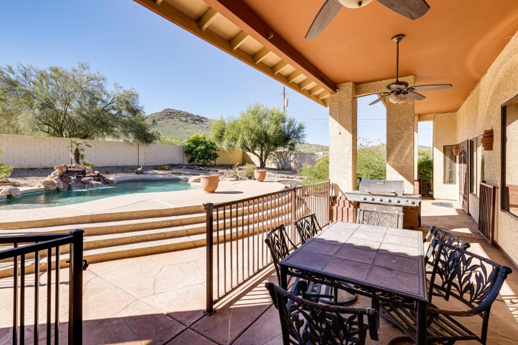 a patio with a table and chairs and a swimming pool at Groups Welcome! Home w/ Pool + Patio in N Phoenix in Phoenix