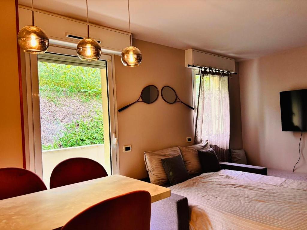 a bedroom with a large bed and a window at Monte Carlo Vista in Beausoleil