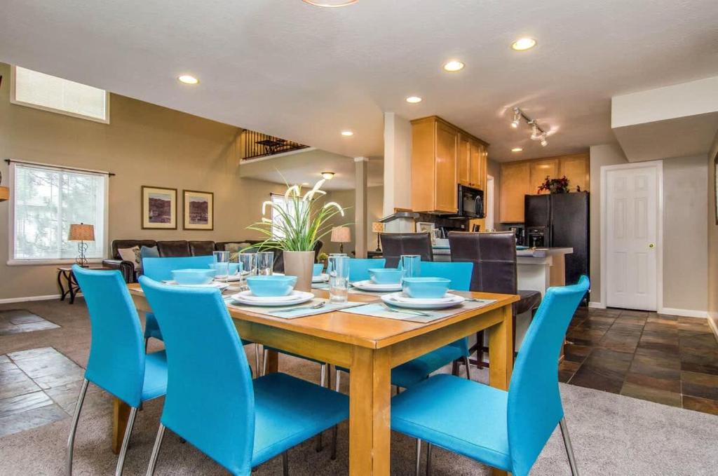 a dining room with a table and blue chairs at Union Grove in Salt Lake with Hot Tub and Foosball in Midvale