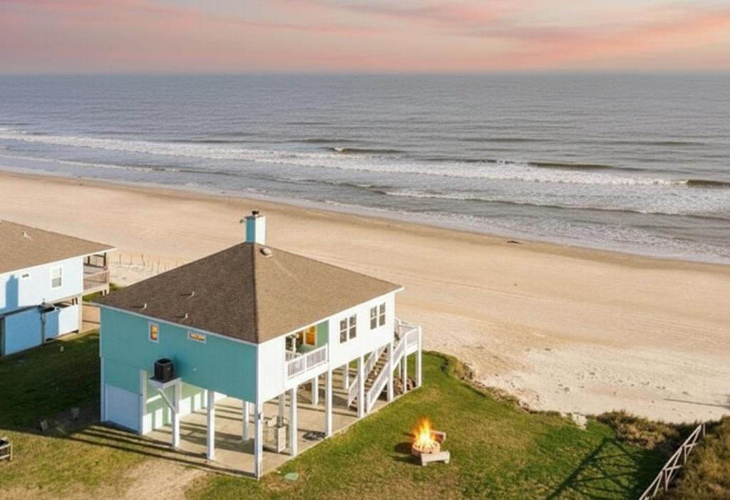 an aerial view of a house on the beach at Paradise Beachfront Firepit Couples Retreat in Caplen