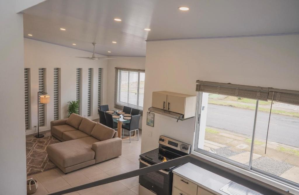 a living room with a couch and a table at 3-bedroom The Dream House - Herradura & Los Sueños Getaway in Herradura