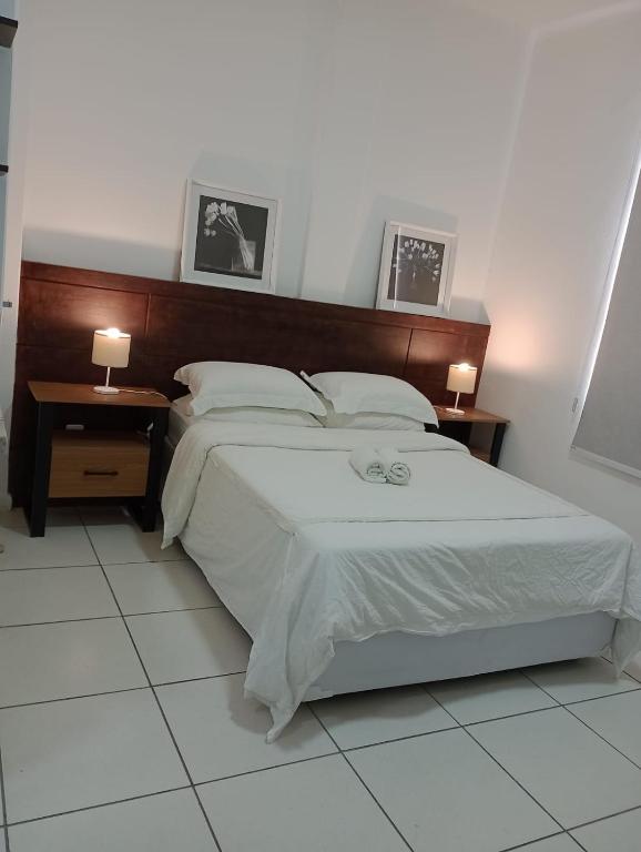 a bedroom with a large bed with two night stands at Condo ipanema 209 in Rio de Janeiro