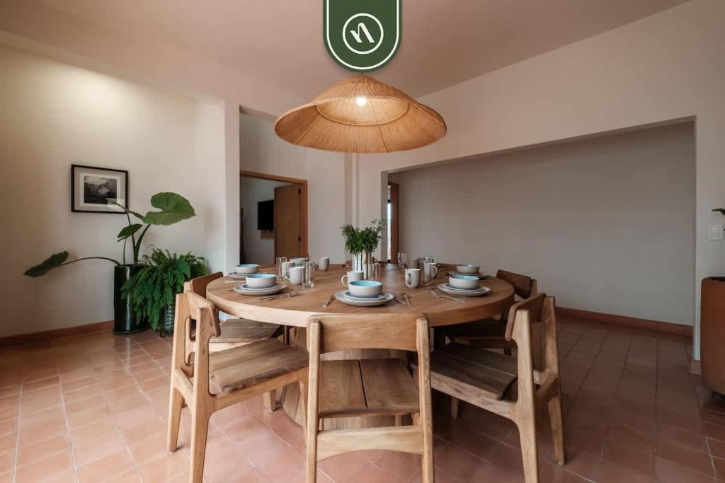a dining room with a wooden table and chairs at Centric 3BR Condo in Downtown in Oaxaca in Oaxaca City
