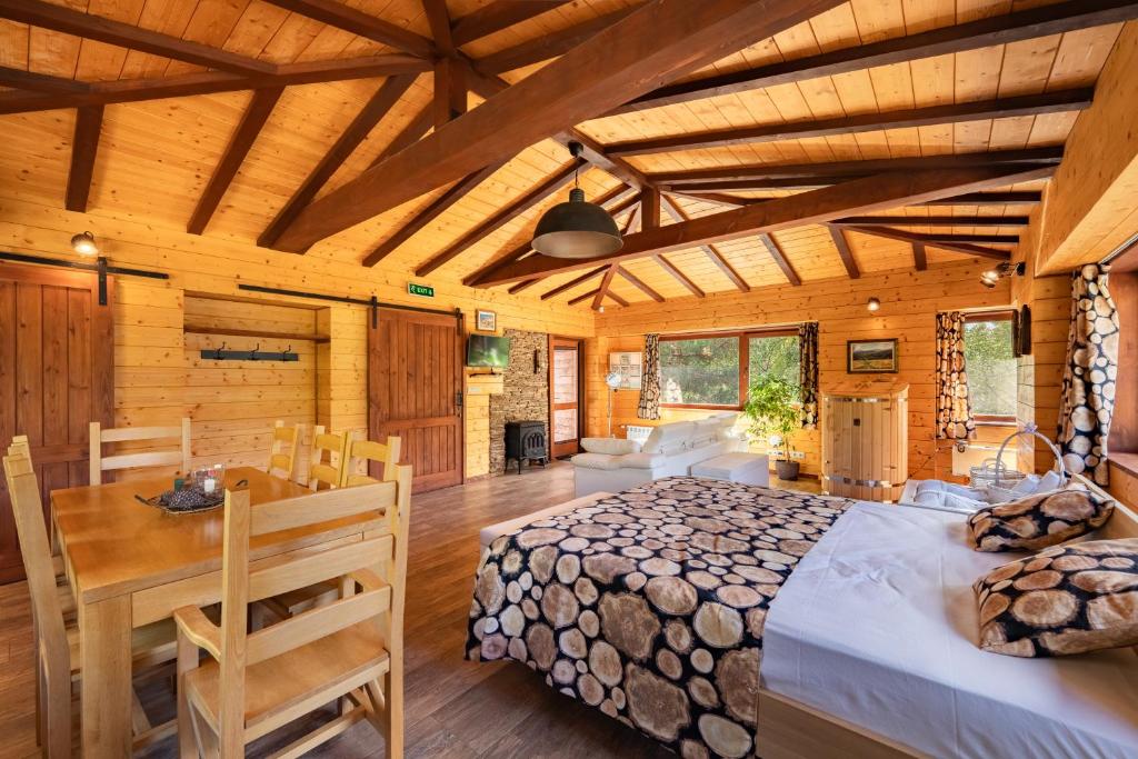 a bedroom with a bed and a table in a room at Abies Alba in Yarema residence zone