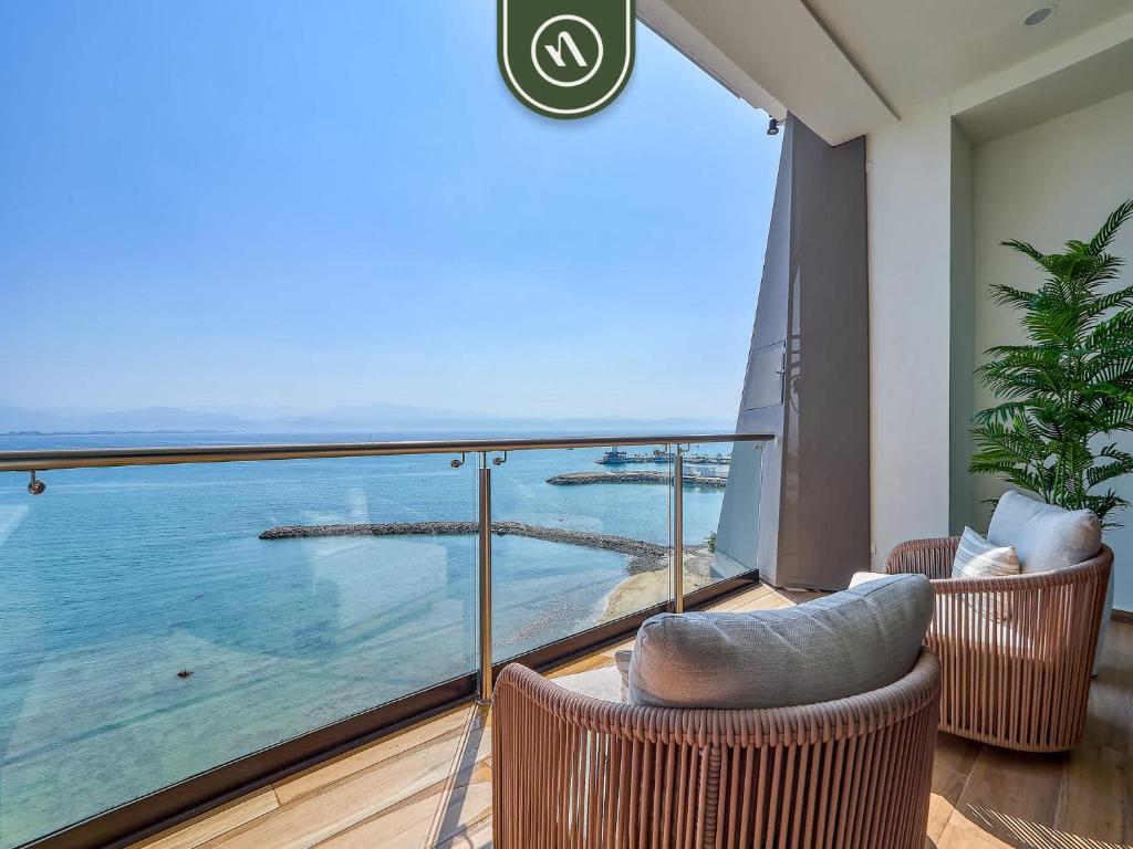 a balcony with chairs and a view of the ocean at Luxury Oceanfront 3 BR Condo with Balcony in Cruz de Huanacaxtle