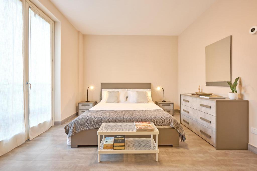 um quarto com uma cama grande e uma cômoda em Tra la Rocca e il Lago em Angera