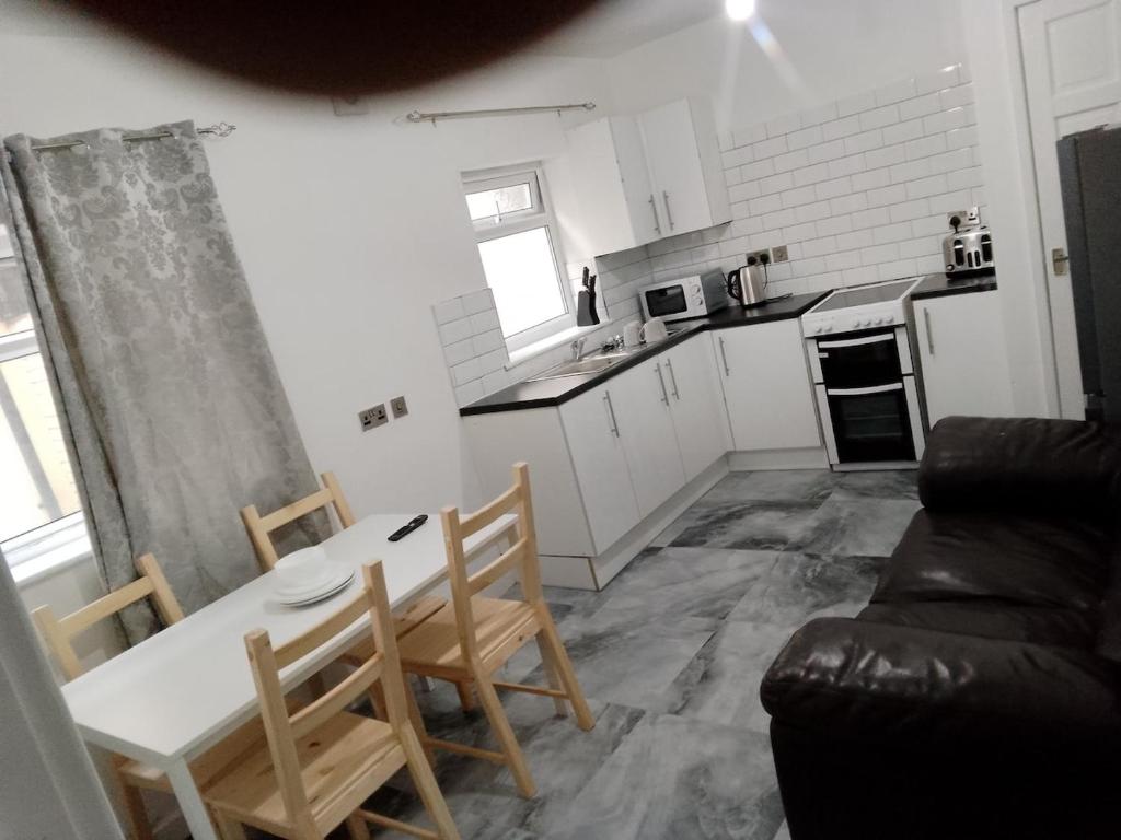 a kitchen with a table and chairs in a room at Modern 2 bedrooms Apartment- Ashton-Under-Lyne- Hosts 5 persons in Ashton under Lyne