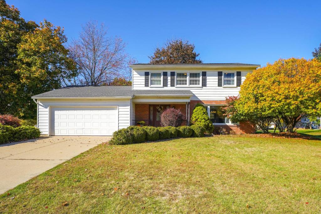 a large white house with a garage at 3 Mi to Dtwn Home with Fire Pit and Yard in Jackson in Jackson