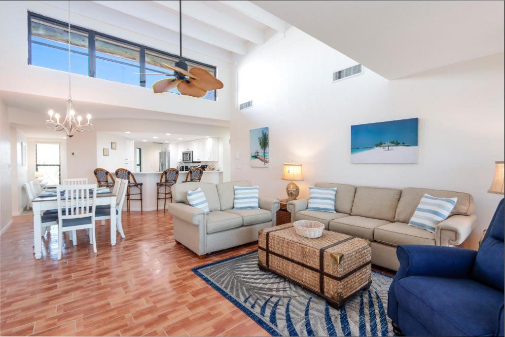a living room with a couch and a table at Bandy Beach D201- Gulf Front Luxury in Sanibel
