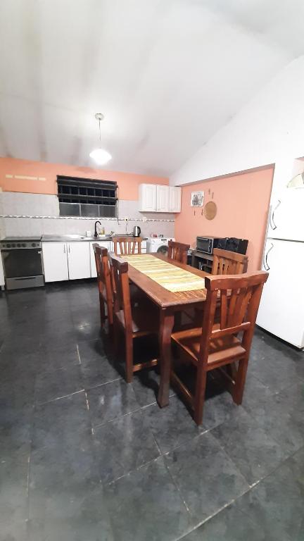 a kitchen with a wooden table and chairs at Casa Los Abuelos in La Granja