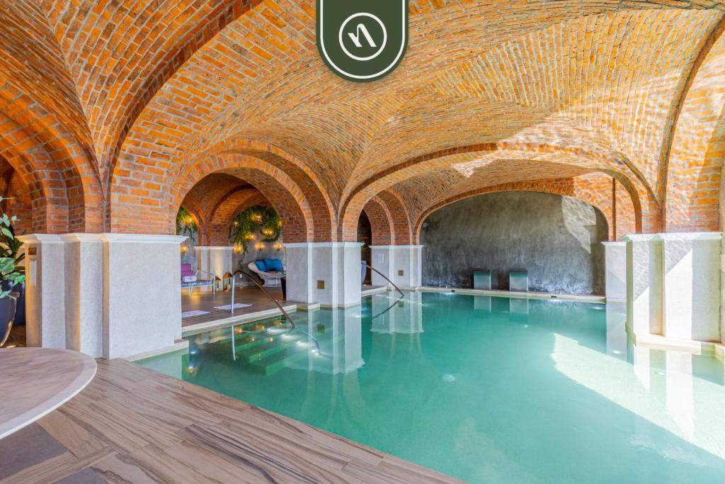 a swimming pool in a brick building with water in it at 2BR Condo with Private Terrace - Ocean View - Pool in El Tule