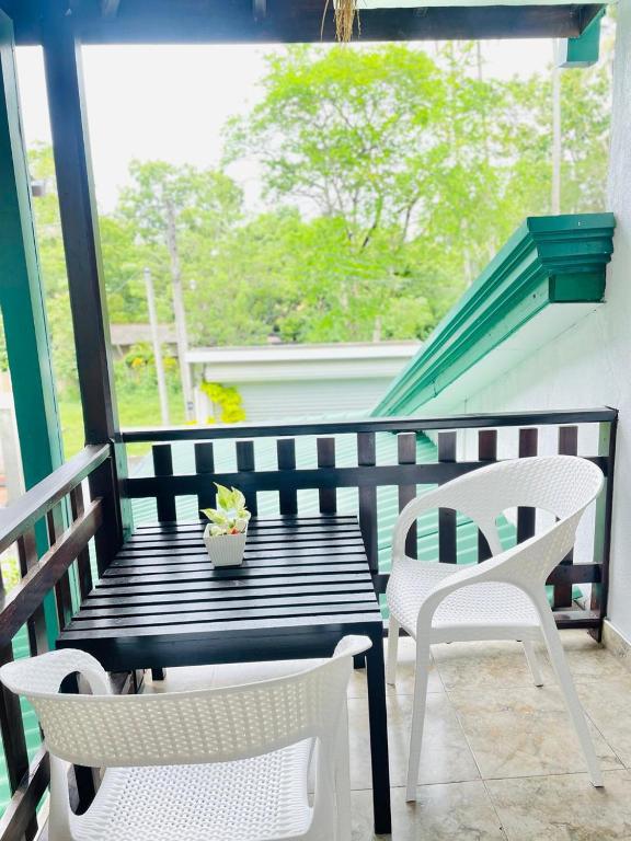 a porch with a table and chairs and a window at Sahas Homestay in Tangalle