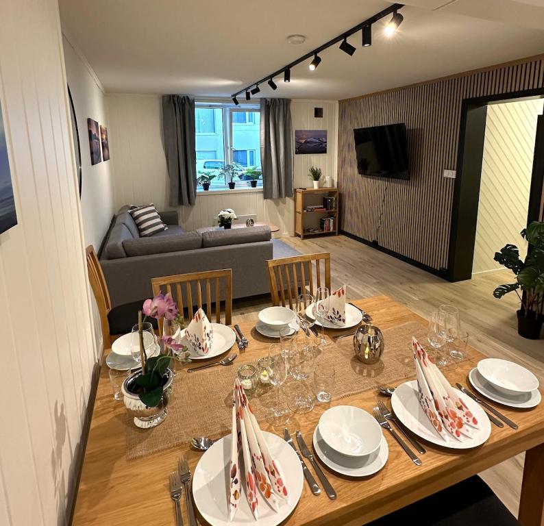 a dining room with a table and a living room at City apt with 2 bedrooms and kitchen - Hydrus in Tromsø