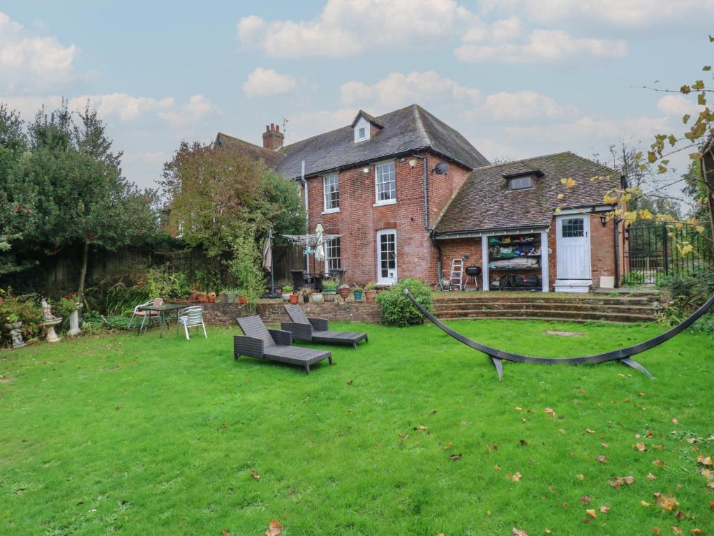 a house with a yard with a hammock in front of it at Chilton Manor House in Murston