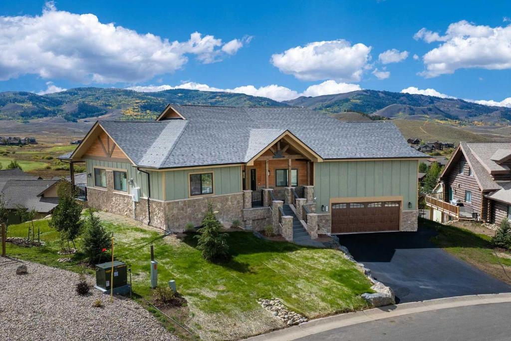 a house with a mountain in the background at Saddle Ridge in Granby