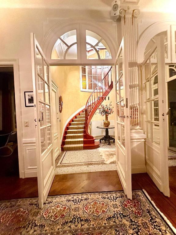 a hallway with a spiral staircase in a house at La Ruche Oostende in Ostend