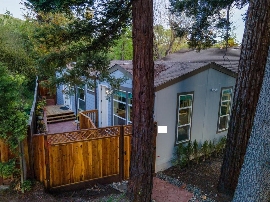 a small blue house with a wooden fence at Privately Secluded Guesthouse in Fremont