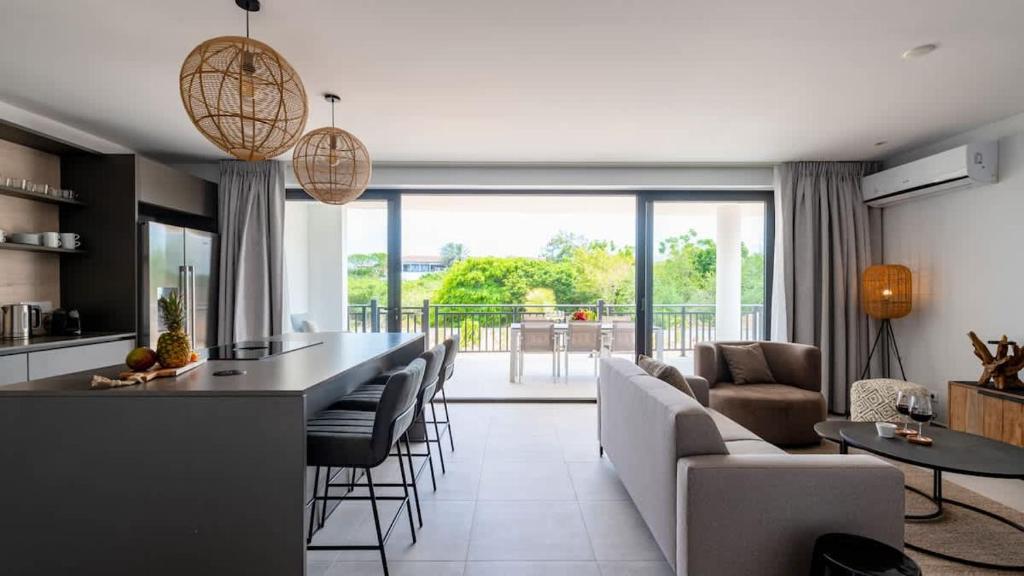 a kitchen and living room with a couch and a table at Dushi Breeze in Blue Bay
