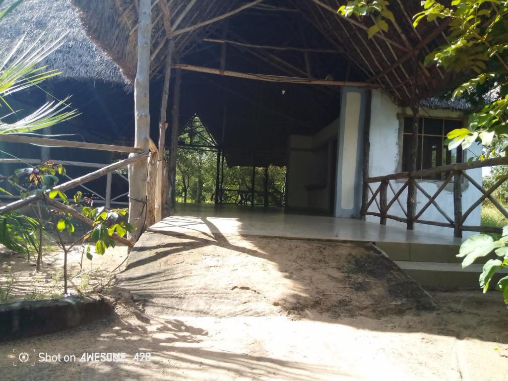 an outside view of a house with a porch at Malombo Selous Forest Camp in Kwangwazi
