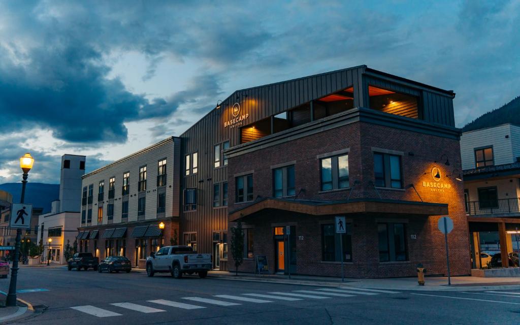 a building on a street with a truck parked in front at Basecamp Suites Revelstoke in Revelstoke