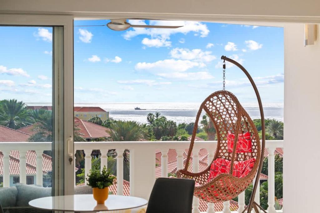 Una vista del océano desde el balcón de una casa. en Little Dreams, en Dorp Sint Michiel