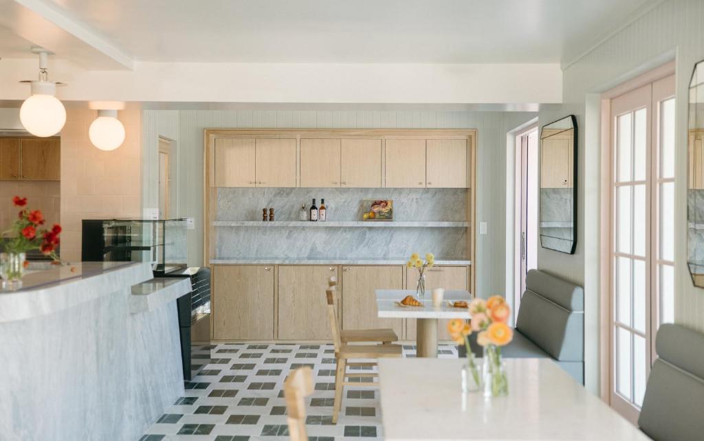 a kitchen with a table and a dining room at Bay Shores Peninsula Hotel in Newport Beach