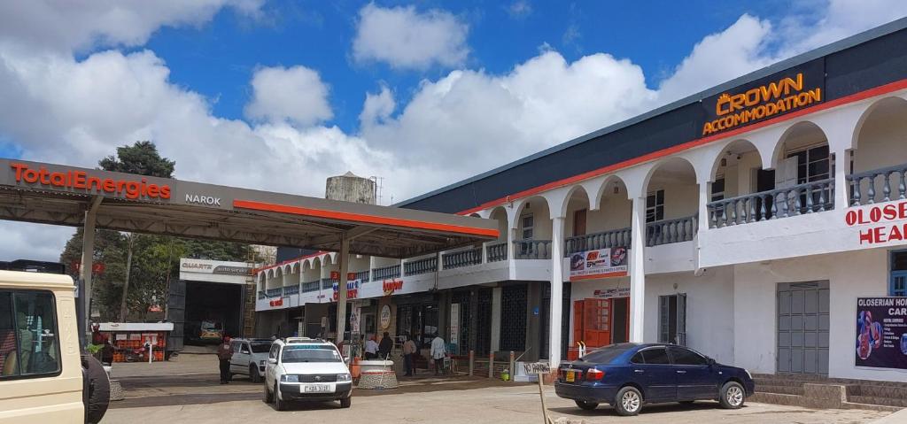 a gas station with cars parked in a parking lot at Crown Accommodation Narok in Narok