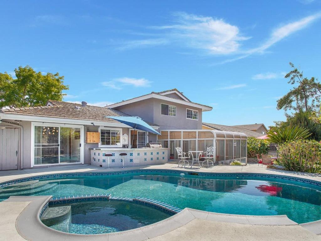 a swimming pool in front of a house at Charming Villa with Backyard Oasis Close to Beach in Laguna Hills