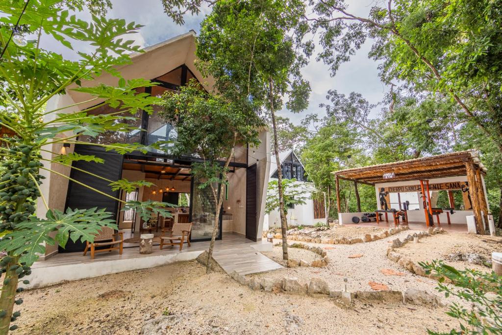 a house in the middle of a forest at Xtambaa Selva in Tulum