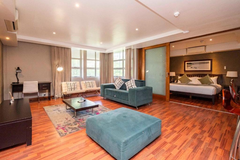 a large living room with a couch and a bed at Hint of Luxury at Circa in Cape Town