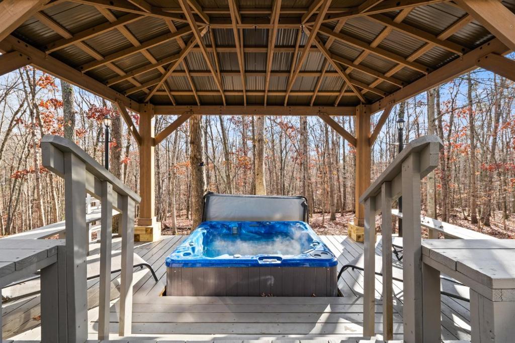 a gazebo with a hot tub on a deck at Cozy Mountain Song- Massanutten Mountain in Hopkins Spring