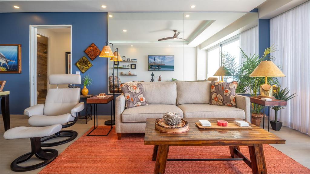 a living room with a couch and a table at Encantame Towers Verano 1401 in Puerto Peñasco