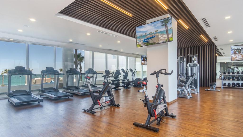 a gym with treadmills and cardio equipment in a building at Encantame Towers Viento 304 in Playa Encanto