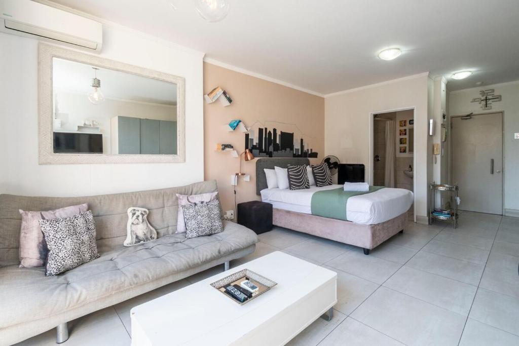 a living room with a couch and a bed at City Light & Mountain Sight in Cape Town