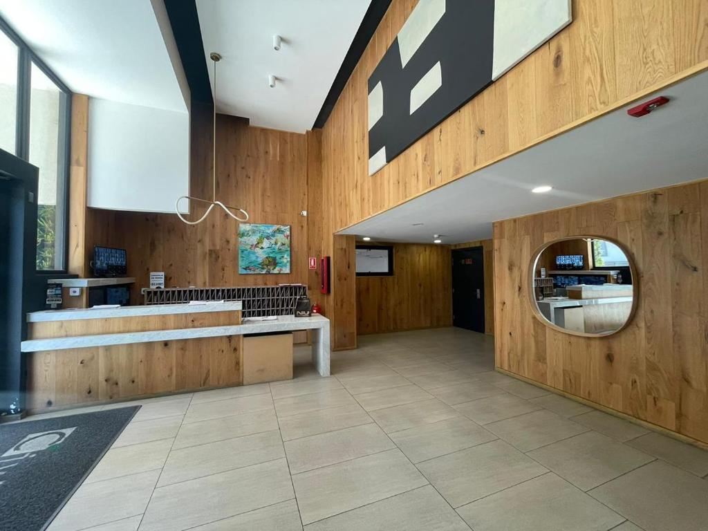 a large lobby with wooden walls and a mirror at Departamento studio nuevo en Concepcion in Concepción