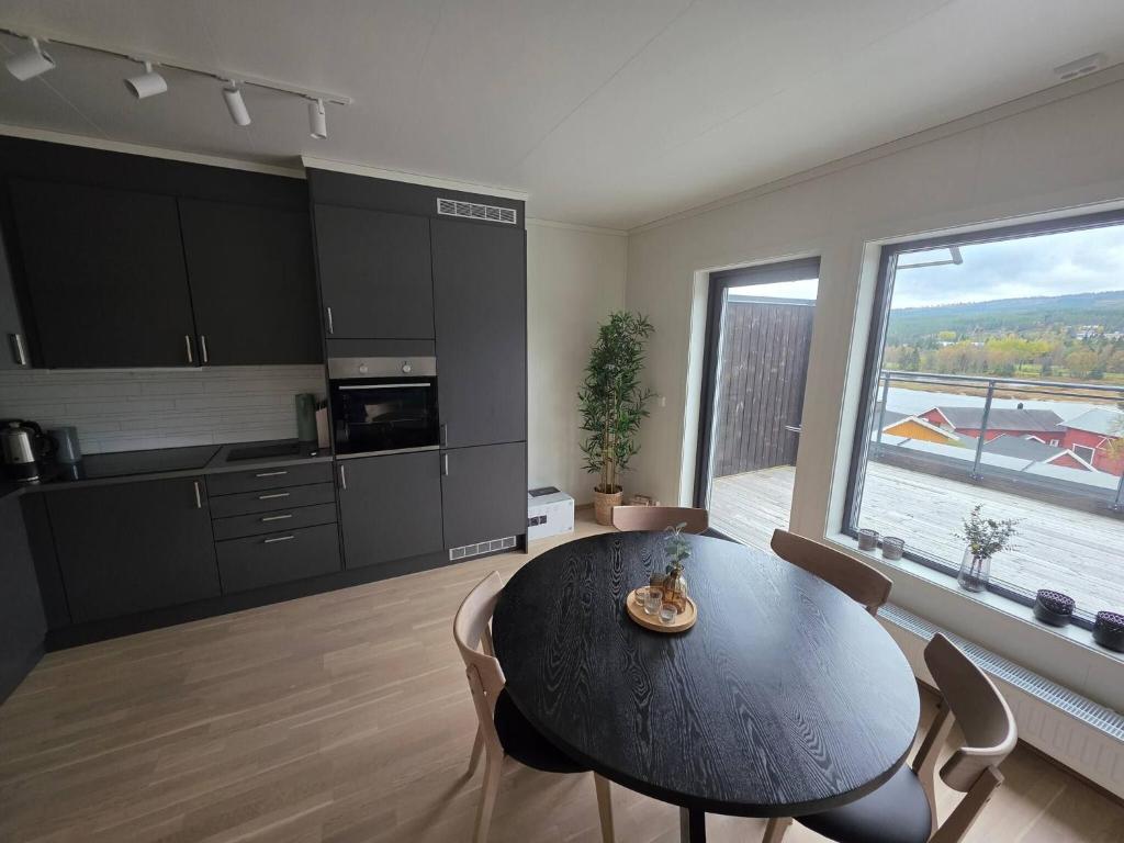 a kitchen with a table and a large window at Nice apartment in the center of Trysil 402 in Trysil