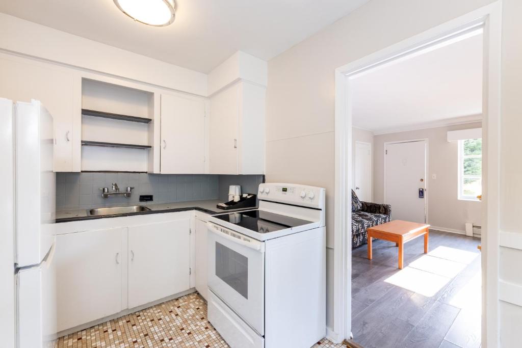 a kitchen with white cabinets and a stove at 2400 Motel in Vancouver